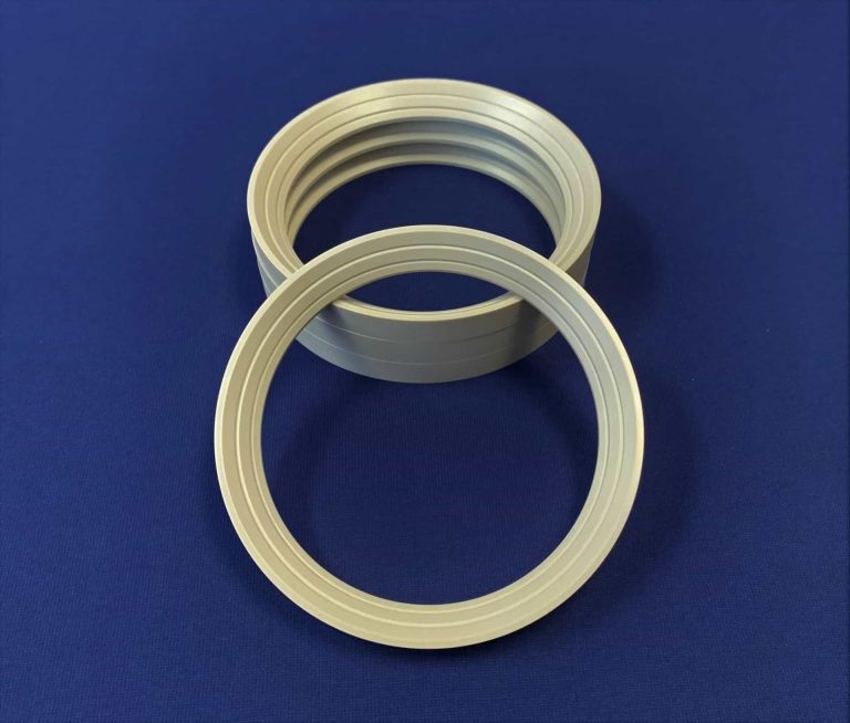Two white plastic rings on a blue background.